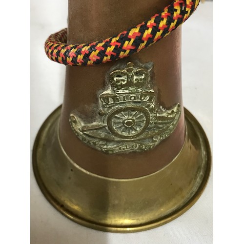 946 - A military brass and copper bugle horn with Argyll and Sutherland brass badge, cord and tassels, tog... 