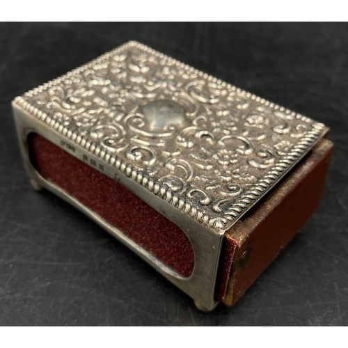 707 - An embossed hallmarked silver match box holder. Birmingham 1906 maker Cornelius Desormeaux Saunders ... 