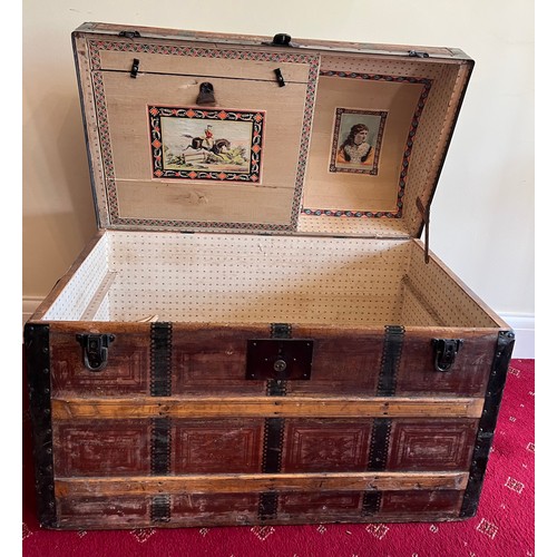 25 - A 19thC dome topped wooden bound trunk with metal fittings and leather carrying handles. 88 w x 50 d... 