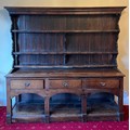 A 19thC oak 3 drawer dresser with rack to back. 180 h x 185 w x 43cm d.