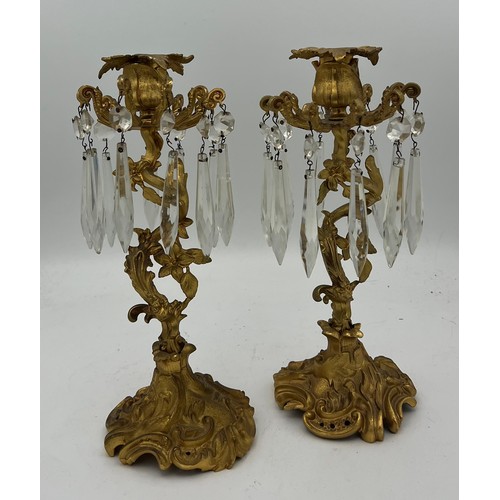 1022 - A pair of ormolu candlesticks with crystal drops. 26cm h.