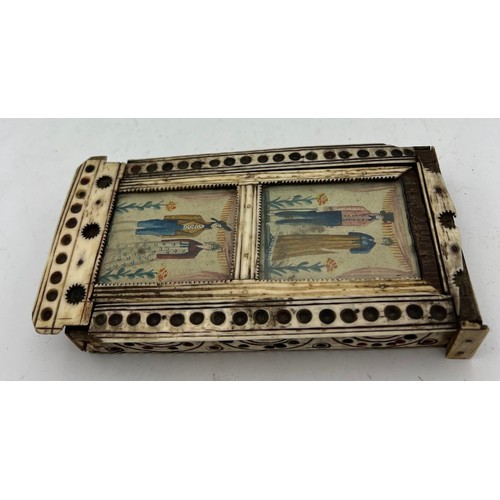 1024 - A Napoleonic prisoner of war box containing dominoes and two dice. Painted scenes to top. 15 x 8cm. ... 