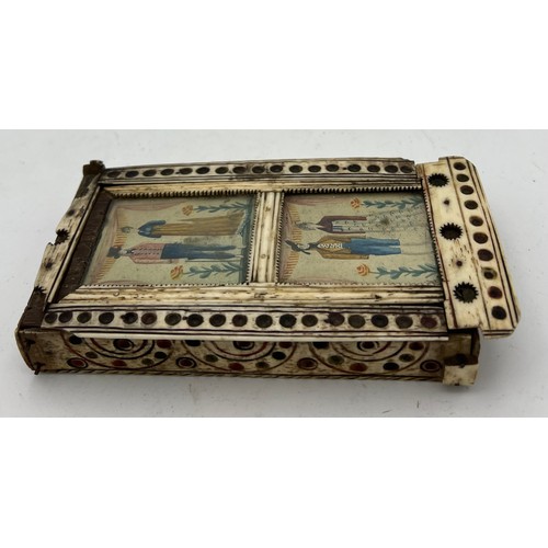 1024 - A Napoleonic prisoner of war box containing dominoes and two dice. Painted scenes to top. 15 x 8cm. ... 