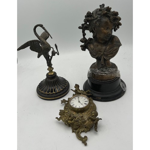 1025 - Nineteenth century bronze figure, brass wall mounted clock and a metal figure of heron and snake 22c... 