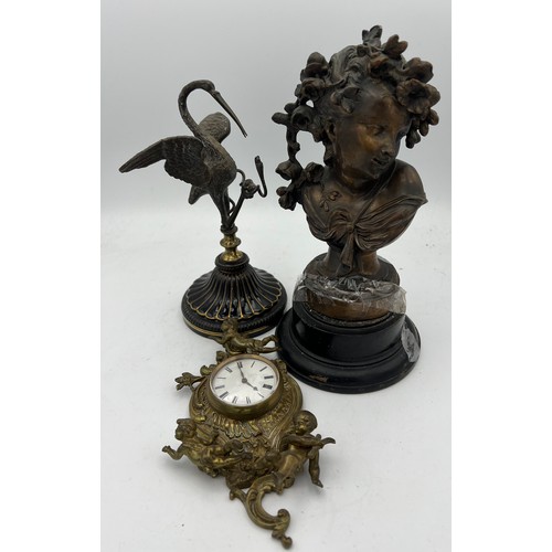 1025 - Nineteenth century bronze figure, brass wall mounted clock and a metal figure of heron and snake 22c... 