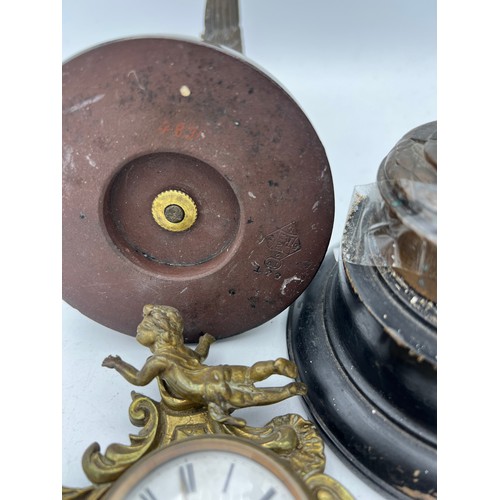 1025 - Nineteenth century bronze figure, brass wall mounted clock and a metal figure of heron and snake 22c... 