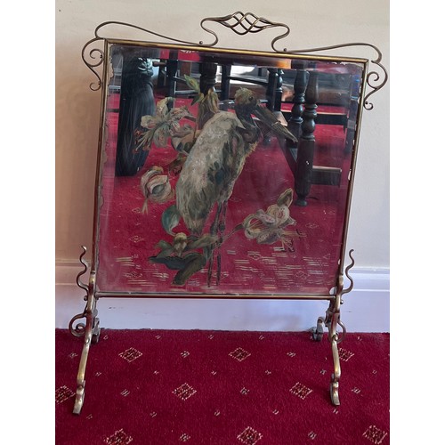 1028 - A 19thC brass framed mirrored fire screen painted with dodo and flowers.