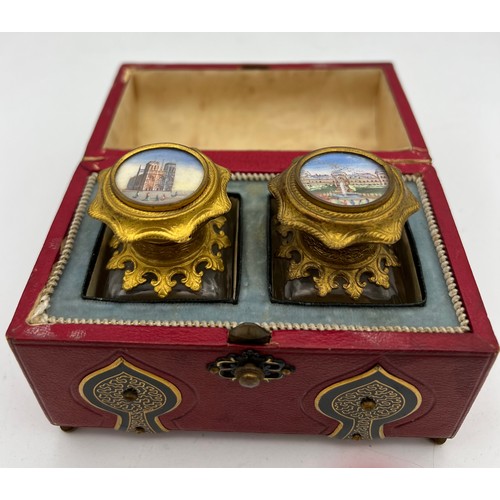 1043 - Red leather covered casket containing two glass and gilt metal scent bottles with painted tops and i... 