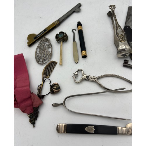 1063 - An interesting miscellany to include French silver and ebony knife, two fleams, Chinese metal comb, ... 