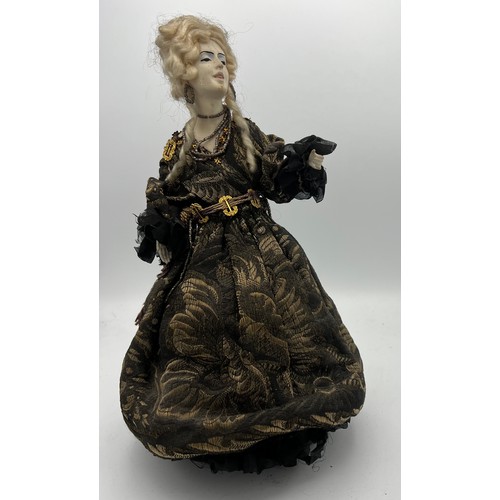 1064 - A 19thC doll with bisque heads and arms on a weighted base. 32cm h.