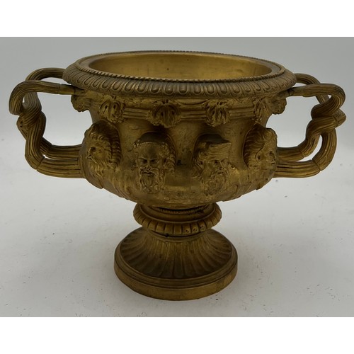 1066 - A 19thC heavy ormolu Warwick vase. 17cm h.