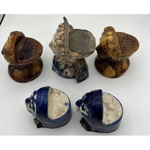 208 - Nineteenth century pottery furniture rests, two pairs and a single. Three modelled as female heads, ... 