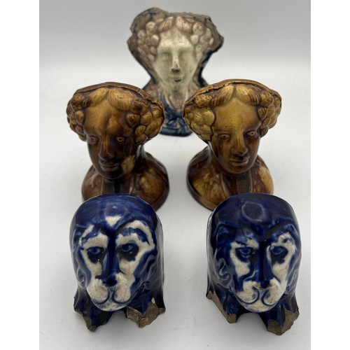 208 - Nineteenth century pottery furniture rests, two pairs and a single. Three modelled as female heads, ... 