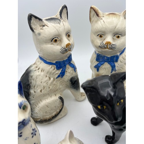 209 - Eight various 19th/20th C ceramic cats to include Royal Doulton and Sylvac. Tallest 20cm h.