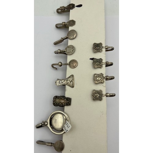 463 - Nine hallmarked silver napkin holders, various dates and makers together with four marked sterling.