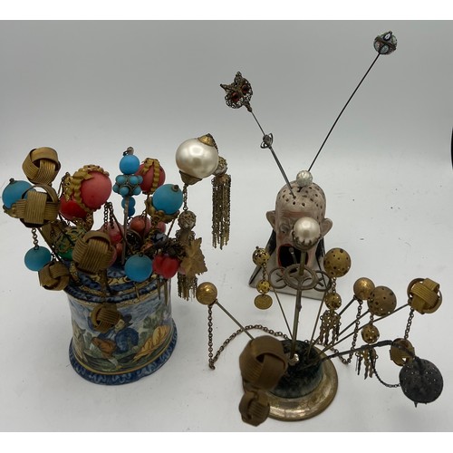 465 - A quantity of 19th and early 20thC hat pins and hair ornaments together with majolica and bisque hat... 