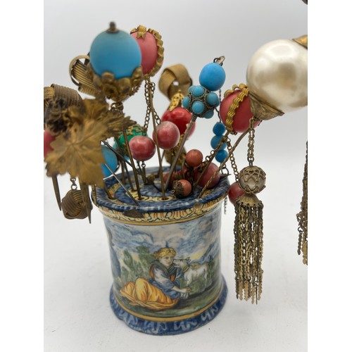 465 - A quantity of 19th and early 20thC hat pins and hair ornaments together with majolica and bisque hat... 