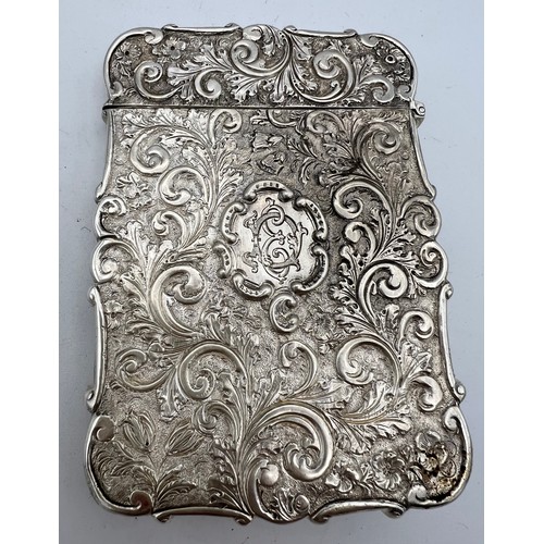 717 - A Victorian silver castle-top card case. The Royal Exchange London in high relief with a foliage scr... 