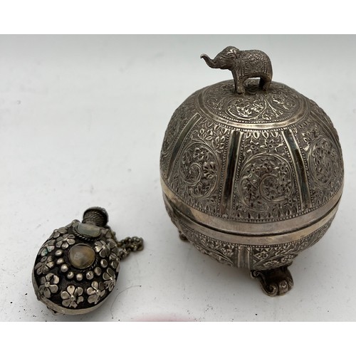 721 - Indian white metal lidded bowl 11cm h  together with a white metal snuff bottle.