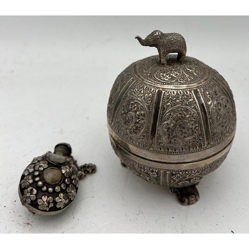 721 - Indian white metal lidded bowl 11cm h  together with a white metal snuff bottle.