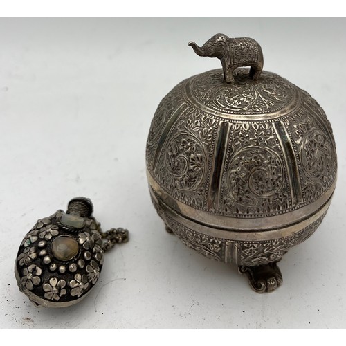 721 - Indian white metal lidded bowl 11cm h  together with a white metal snuff bottle.