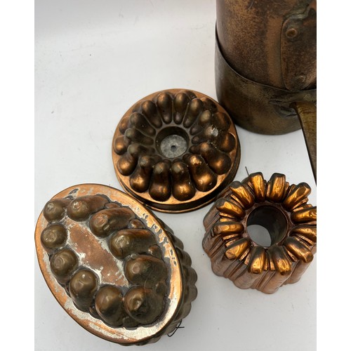 820 - Two vintage copper pans together with three copper and metal jelly moulds. Oval mould 18 x 12cm.