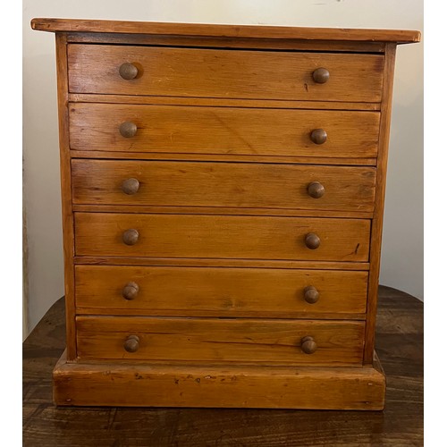 790 - A six drawer pine collectors cabinet with glass tops to drawers. 42 cm h x 22cm d x 38cm w. Label to... 