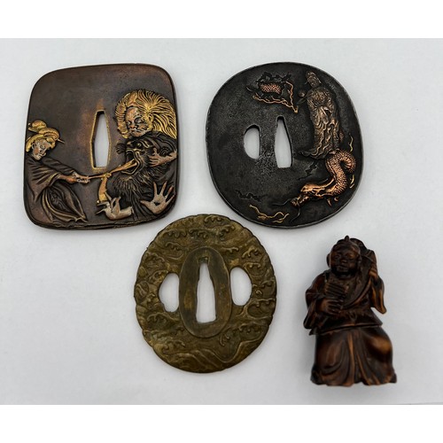 927 - Three Japanese Tsuba 8 x 7.5cm approximately, together with a wooden netsuke.