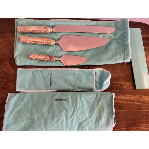 684 - A Tiffany and Co. Chrysanthemum pattern cake knife 31cm l and two cake slices in protective covers a... 