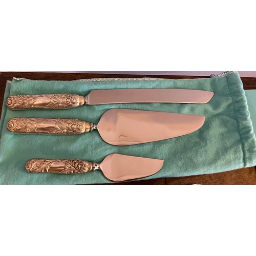 684 - A Tiffany and Co. Chrysanthemum pattern cake knife 31cm l and two cake slices in protective covers a... 