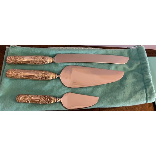 684 - A Tiffany and Co. Chrysanthemum pattern cake knife 31cm l and two cake slices in protective covers a... 