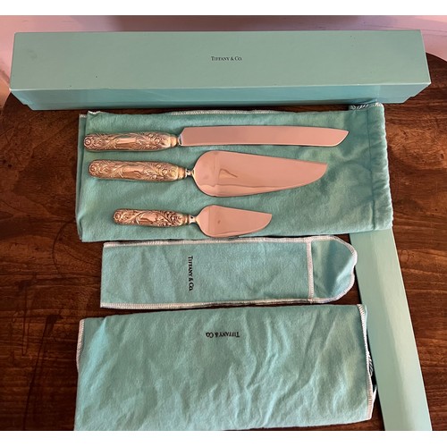 684 - A Tiffany and Co. Chrysanthemum pattern cake knife 31cm l and two cake slices in protective covers a... 