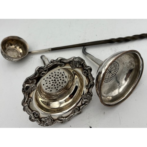 686 - Two 19thC silver plated wine funnels with strainers together with a white metal and baleen toddy lad... 