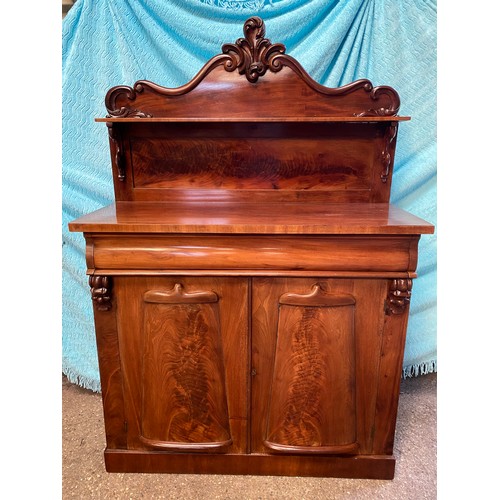 92 - A mahogany chiffonier, carved shaped back with a single shelf raised on scroll supports, above one l... 