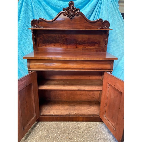 92 - A mahogany chiffonier, carved shaped back with a single shelf raised on scroll supports, above one l... 