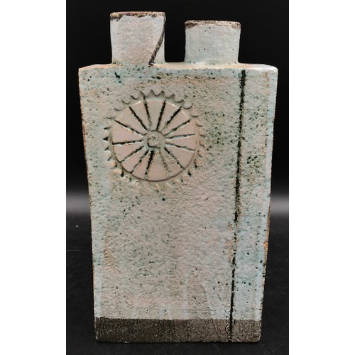 122 - A studio pottery slab vase with two cylindrical openings to the top and a circular pattern engraved ... 