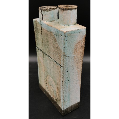 122 - A studio pottery slab vase with two cylindrical openings to the top and a circular pattern engraved ... 