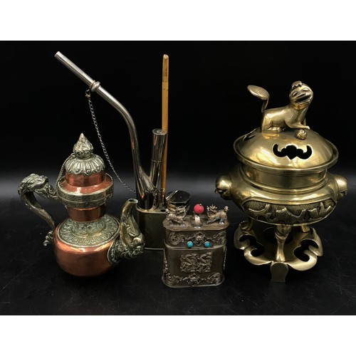 921 - Oriental items to include a Chinese brass incense burner on three feet and stand, A Tibetan teapot w... 