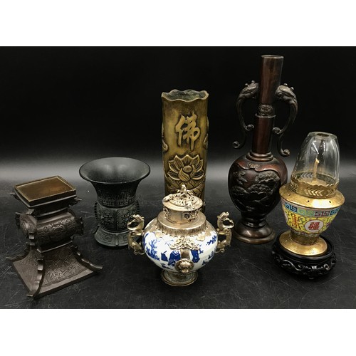 924 - A collection of oriental items to include four vases tallest 25cm h, a blue and white incense burner... 