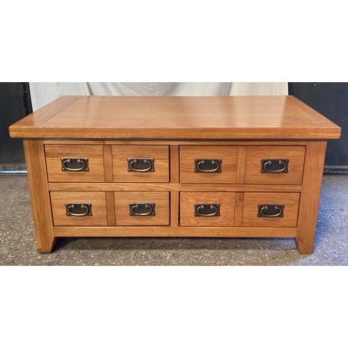 80 - An oak coffee table with four double ended drawers. 51 h x 110 w x 60cm d.