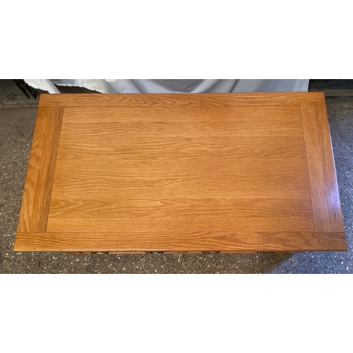 80 - An oak coffee table with four double ended drawers. 51 h x 110 w x 60cm d.