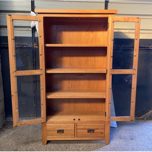 83 - An oak glazed display cabinet/ bookcase with 3 shelves over 2 drawers. 181 h x 100 w x 40cm d.