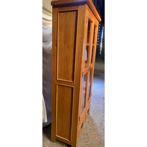 83 - An oak glazed display cabinet/ bookcase with 3 shelves over 2 drawers. 181 h x 100 w x 40cm d.