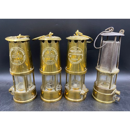 992 - Four miner's lamps, to include three with badge for The Protector Lamp & Lighting Company, each stam... 