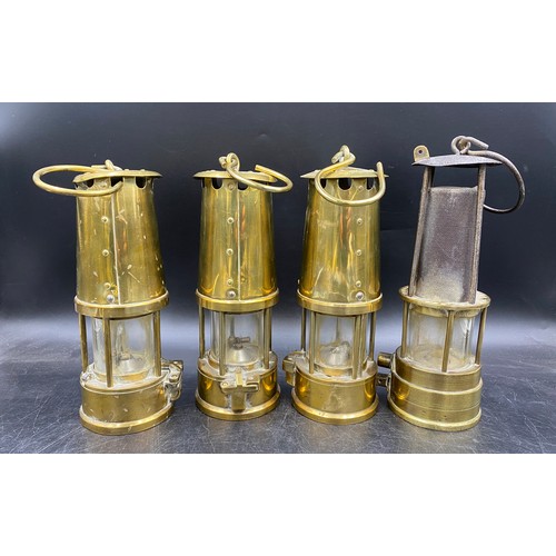 992 - Four miner's lamps, to include three with badge for The Protector Lamp & Lighting Company, each stam... 