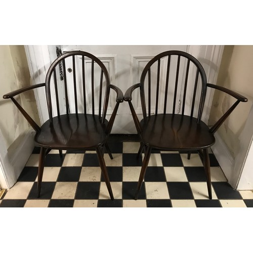 85 - Two Ercol Windsor elbow dining chairs in a stained finish.
Height to back 82cm , height to seat 42cm... 