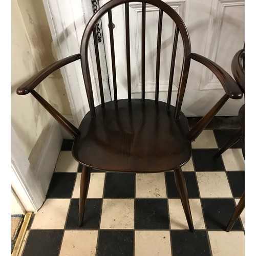 85 - Two Ercol Windsor elbow dining chairs in a stained finish.
Height to back 82cm , height to seat 42cm... 