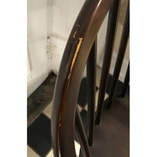 85 - Two Ercol Windsor elbow dining chairs in a stained finish.
Height to back 82cm , height to seat 42cm... 