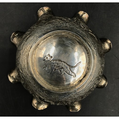 745 - An Indian silver bowl relief embossed decoration depicting elephant, tiger, figure, trees and other ... 