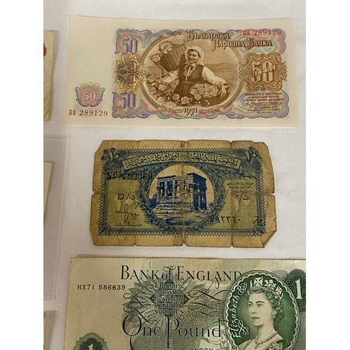 557 - Two ten shilling notes, a one pound note, two U.S. one dollar bills, a 1951 Bulgarian 50 Leva note, ... 